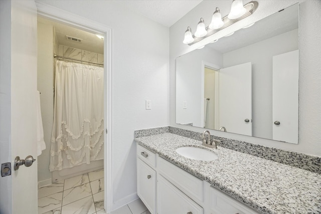 bathroom featuring a shower with curtain, visible vents, baseboards, vanity, and marble finish floor