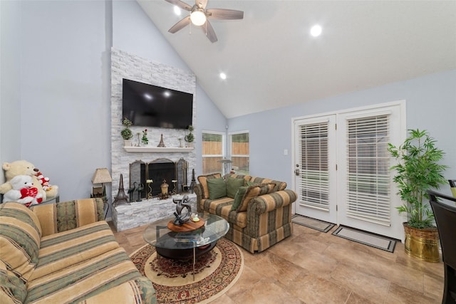 living area featuring high vaulted ceiling, ceiling fan, recessed lighting, and a stone fireplace