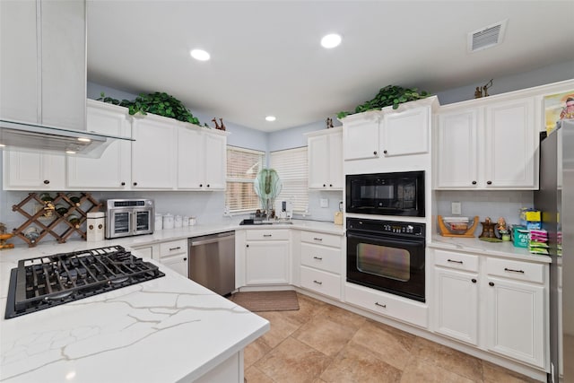 kitchen with visible vents, light stone countertops, recessed lighting, white cabinets, and black appliances