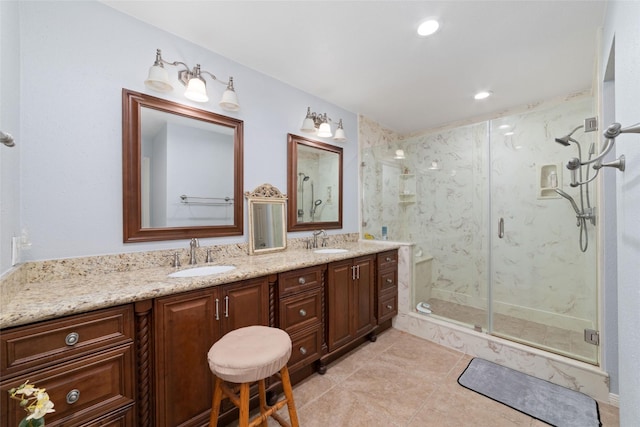 bathroom with double vanity, tile patterned floors, a marble finish shower, and a sink
