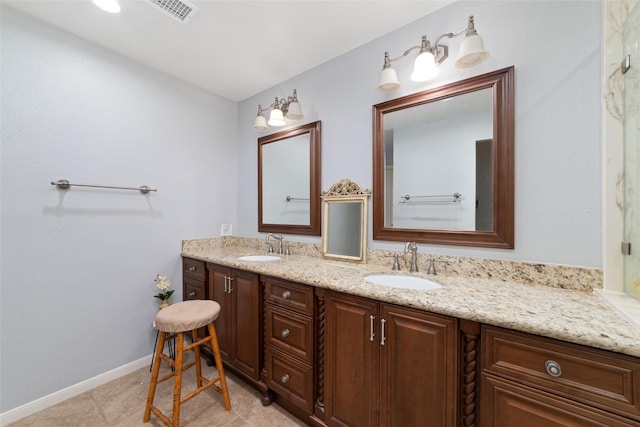 full bathroom featuring visible vents, a sink, baseboards, and double vanity