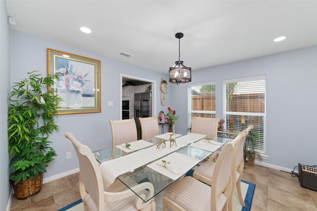dining space featuring baseboards, recessed lighting, and a chandelier