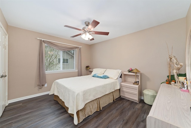 bedroom featuring baseboards, ceiling fan, and dark wood-style floors