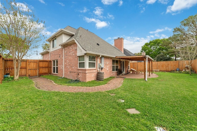 rear view of property with a patio, a fenced backyard, roof with shingles, brick siding, and a yard