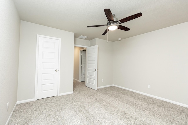 unfurnished bedroom featuring baseboards, visible vents, and light carpet