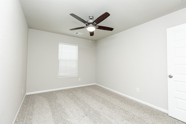 unfurnished room featuring visible vents, a ceiling fan, baseboards, and carpet flooring