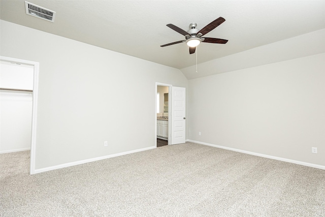 unfurnished bedroom featuring visible vents, baseboards, dark carpet, and a closet