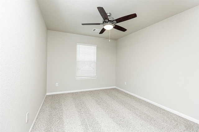 unfurnished room featuring carpet flooring, a ceiling fan, baseboards, and visible vents