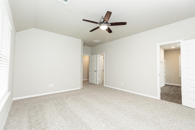 unfurnished bedroom featuring baseboards, carpet, a ceiling fan, and lofted ceiling