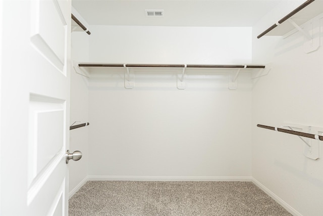 spacious closet featuring visible vents and light carpet