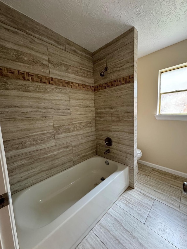 335 Haymarket Ln, Houston, TX 77015 - full bath with toilet, washtub / shower combination, and tile patterned floors