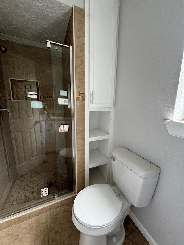 335 Haymarket Ln, Houston, TX 77015 - bathroom featuring baseboards, tile patterned flooring, a shower stall, and toilet