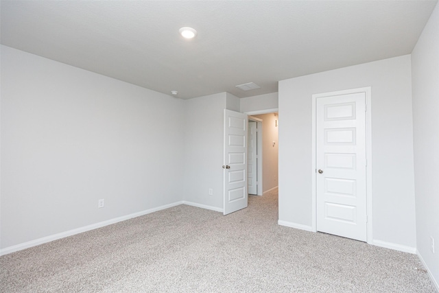 unfurnished bedroom with baseboards, visible vents, and light colored carpet