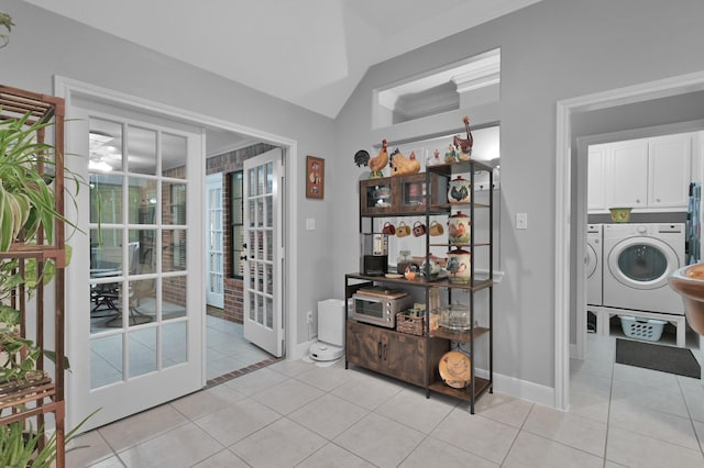 5 Highland Hollow Dr, Conroe, TX 77304 - dining area featuring separate washer and dryer, lofted ceiling, light tile patterned floors, baseboards, and french doors