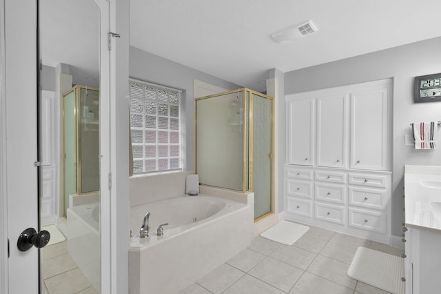 5 Highland Hollow Dr, Conroe, TX 77304 - full bathroom featuring vanity, a garden tub, a stall shower, and tile patterned flooring