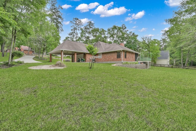 5 Highland Hollow Dr, Conroe, TX 77304 - view of green lawn featuring a carport