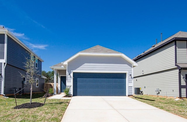 13609 Goldeye Dr, Conroe, TX 77384 - view of front of house with an attached garage, central AC unit, a front lawn, and concrete driveway