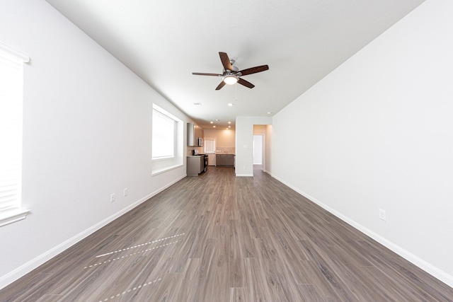 13609 Goldeye Dr, Conroe, TX 77384 - unfurnished living room featuring baseboards, ceiling fan, and wood finished floors