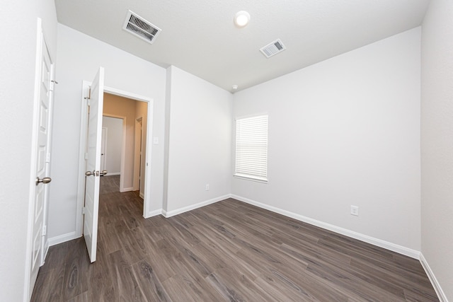 13609 Goldeye Dr, Conroe, TX 77384 - unfurnished bedroom featuring visible vents, dark wood-style flooring, and baseboards