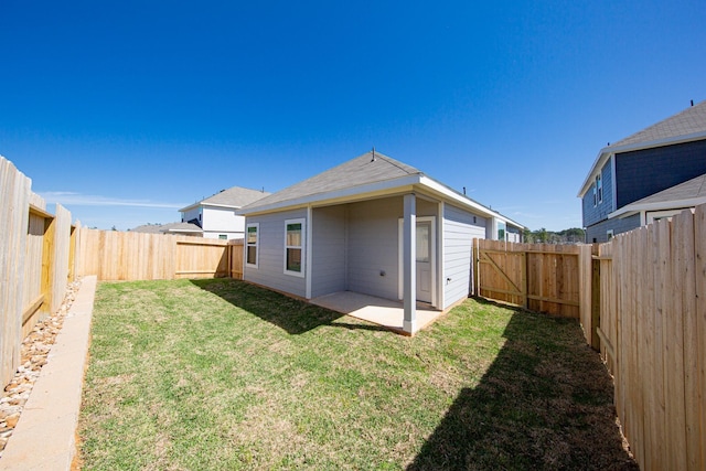 13609 Goldeye Dr, Conroe, TX 77384 - rear view of property featuring a yard, a patio, and a fenced backyard