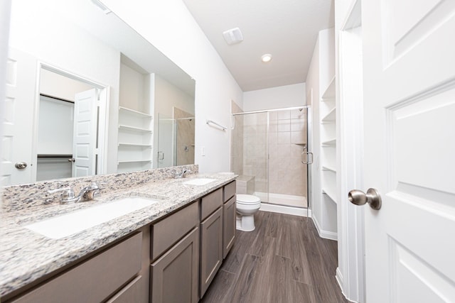 13609 Goldeye Dr, Conroe, TX 77384 - full bath featuring double vanity, a sink, wood finished floors, and a shower stall