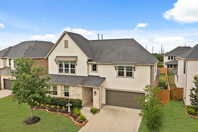 720 Serenity View Ln, Katy, TX 77493 - view of front of property featuring stucco siding, roof with shingles, driveway, an attached garage, and stone siding