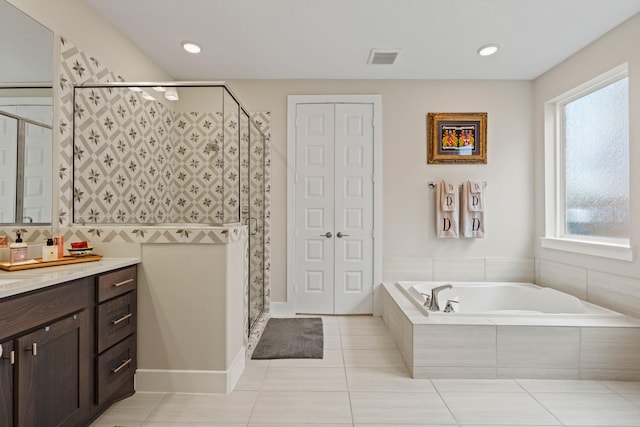 720 Serenity View Ln, Katy, TX 77493 - bathroom with vanity, visible vents, a closet, a bath, and a shower stall