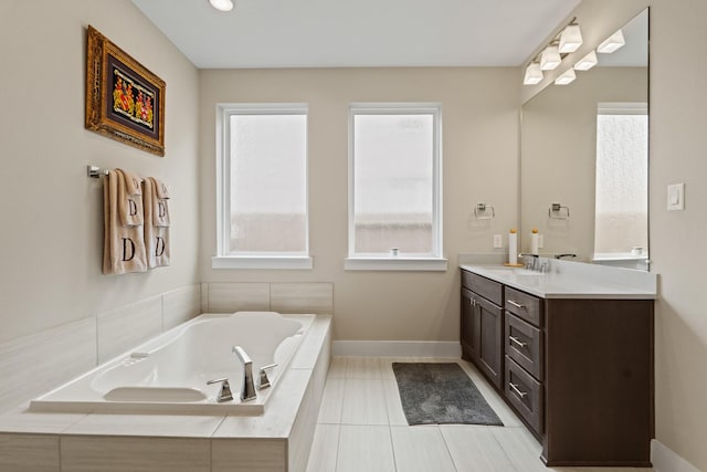 720 Serenity View Ln, Katy, TX 77493 - full bathroom featuring vanity, baseboards, tile patterned flooring, and a bath
