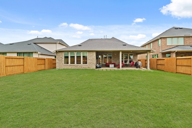 720 Serenity View Ln, Katy, TX 77493 - rear view of house featuring brick siding, a fenced backyard, a patio area, and a yard
