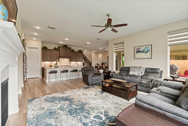720 Serenity View Ln, Katy, TX 77493 - living area featuring light wood finished floors, a ceiling fan, recessed lighting, visible vents, and stairway