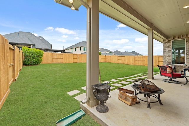 720 Serenity View Ln, Katy, TX 77493 - view of yard featuring a fenced backyard, a patio area, and an outdoor fire pit