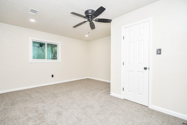 carpeted spare room with baseboards, a ceiling fan, recessed lighting, and visible vents