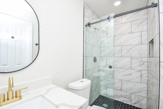 full bathroom with vanity, toilet, and a shower stall