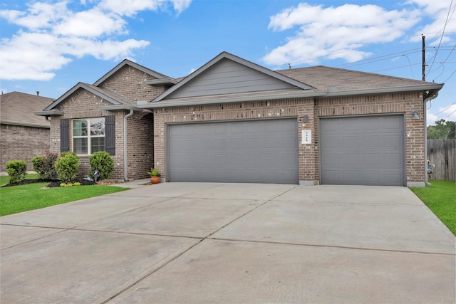 view of front of property with brick siding, concrete driveway, an attached garage, fence, and roof with shingles