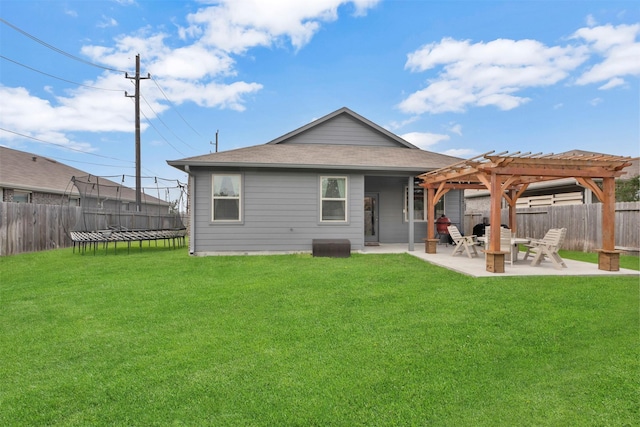back of property with a trampoline, a pergola, a patio area, and a shingled roof
