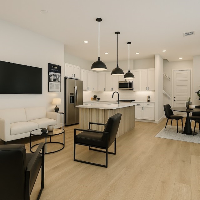 330 Neyland St, Houston, TX 77022 - living area featuring visible vents, recessed lighting, and light wood finished floors