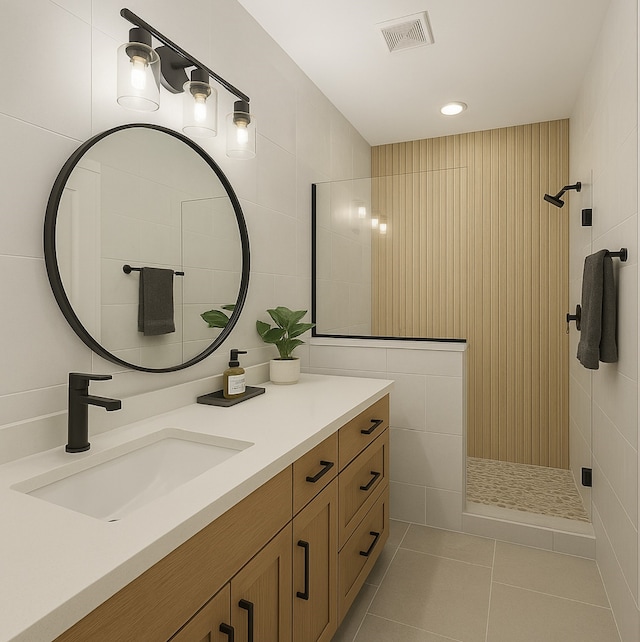 330 Neyland St, Houston, TX 77022 - full bath with visible vents, tile walls, tile patterned flooring, a tile shower, and vanity