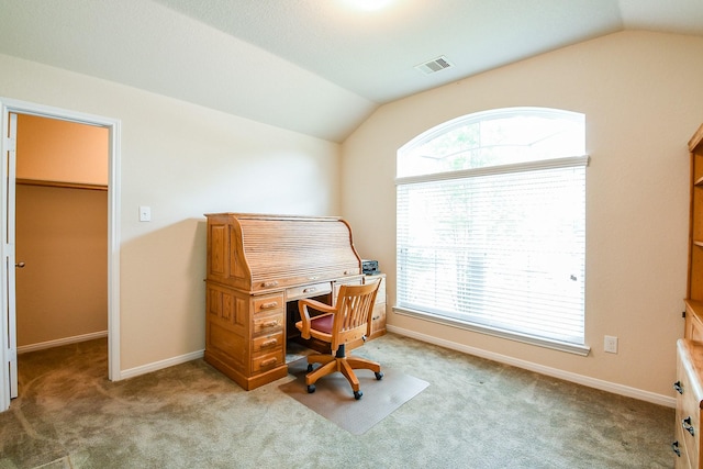 office space featuring carpet floors, baseboards, vaulted ceiling, and visible vents