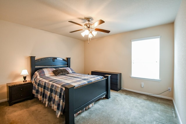 carpeted bedroom with a ceiling fan and baseboards