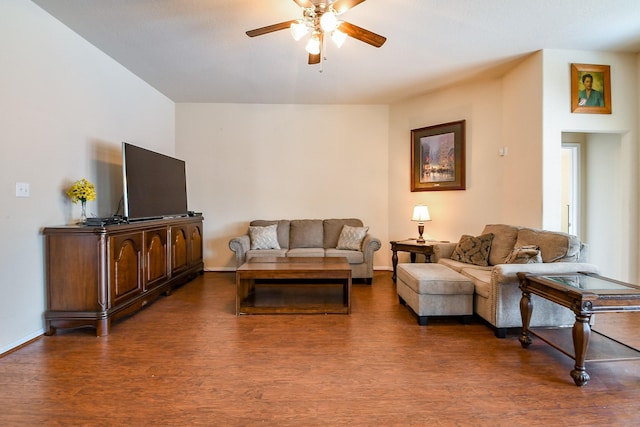 living room featuring baseboards, a ceiling fan, and wood finished floors