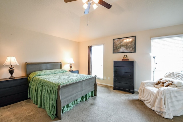 carpeted bedroom featuring baseboards, ceiling fan, and vaulted ceiling