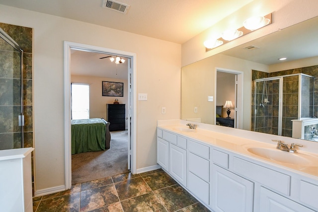 full bathroom featuring connected bathroom, visible vents, tiled shower, and a sink