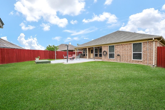 back of house featuring a fenced backyard, a patio area, roof with shingles, and a yard