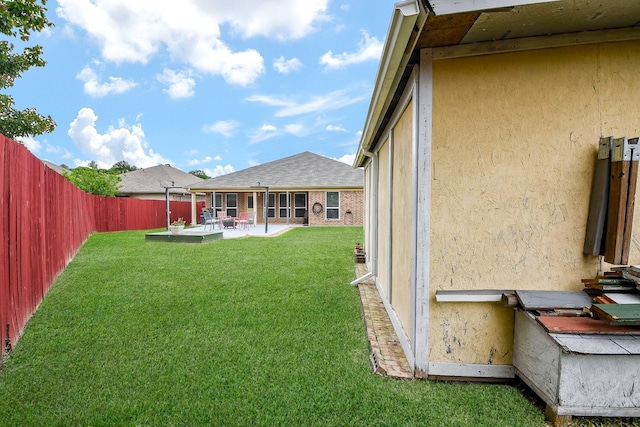 view of yard with a patio and a fenced backyard