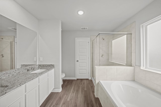 1372 Mount Blanc Path, Conroe, TX 77301 - full bathroom with vanity, toilet, a shower stall, visible vents, and a garden tub