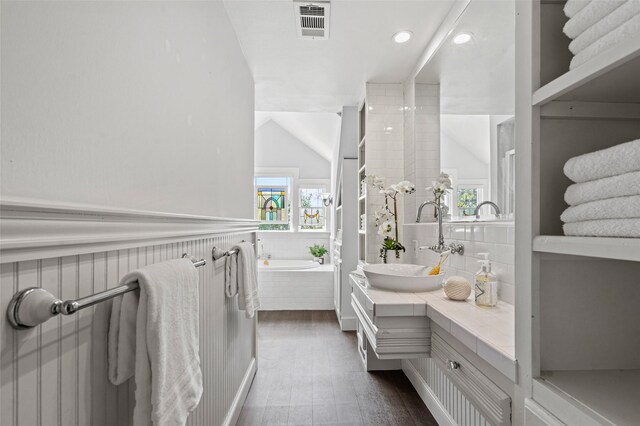 full bath with visible vents, wood finished floors, vanity, lofted ceiling, and recessed lighting