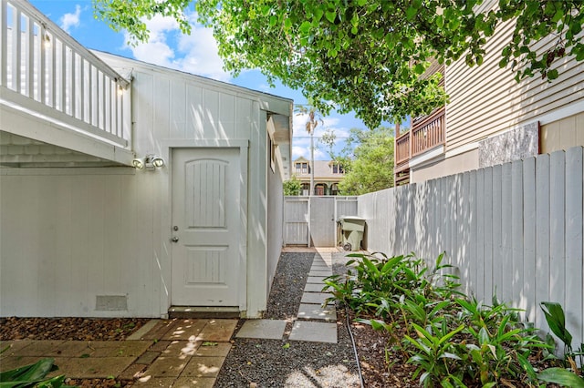 entrance to property featuring fence