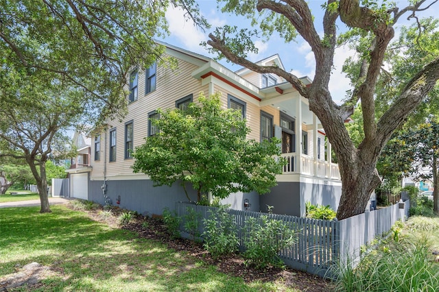 view of side of property with a garage and fence