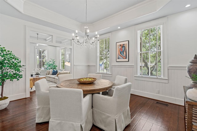 dining area with a notable chandelier, wainscoting, dark wood-style flooring, and visible vents