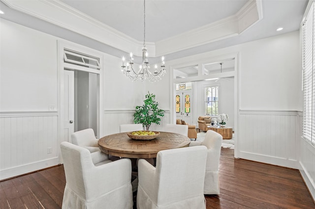 dining room with dark wood-type flooring, recessed lighting, a wainscoted wall, and a notable chandelier
